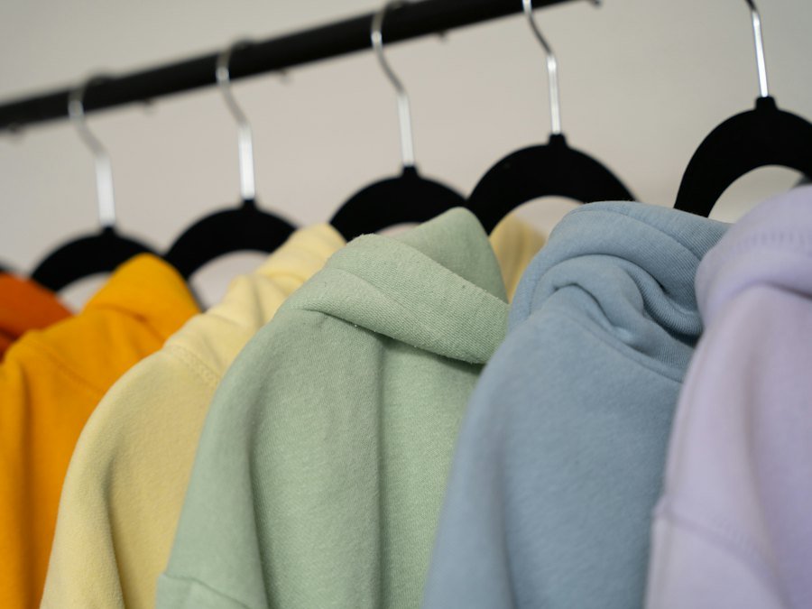 Pastel hoodies hanging on a clothing rack